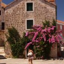 Picturesque-building-with-bouganvillea-drapped-over-its-stone-walls