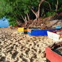 Small fishing boats wait for their owners to take them out through the waves