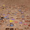 Bottle tops, pepsi, coke lids forming unique sidewalk