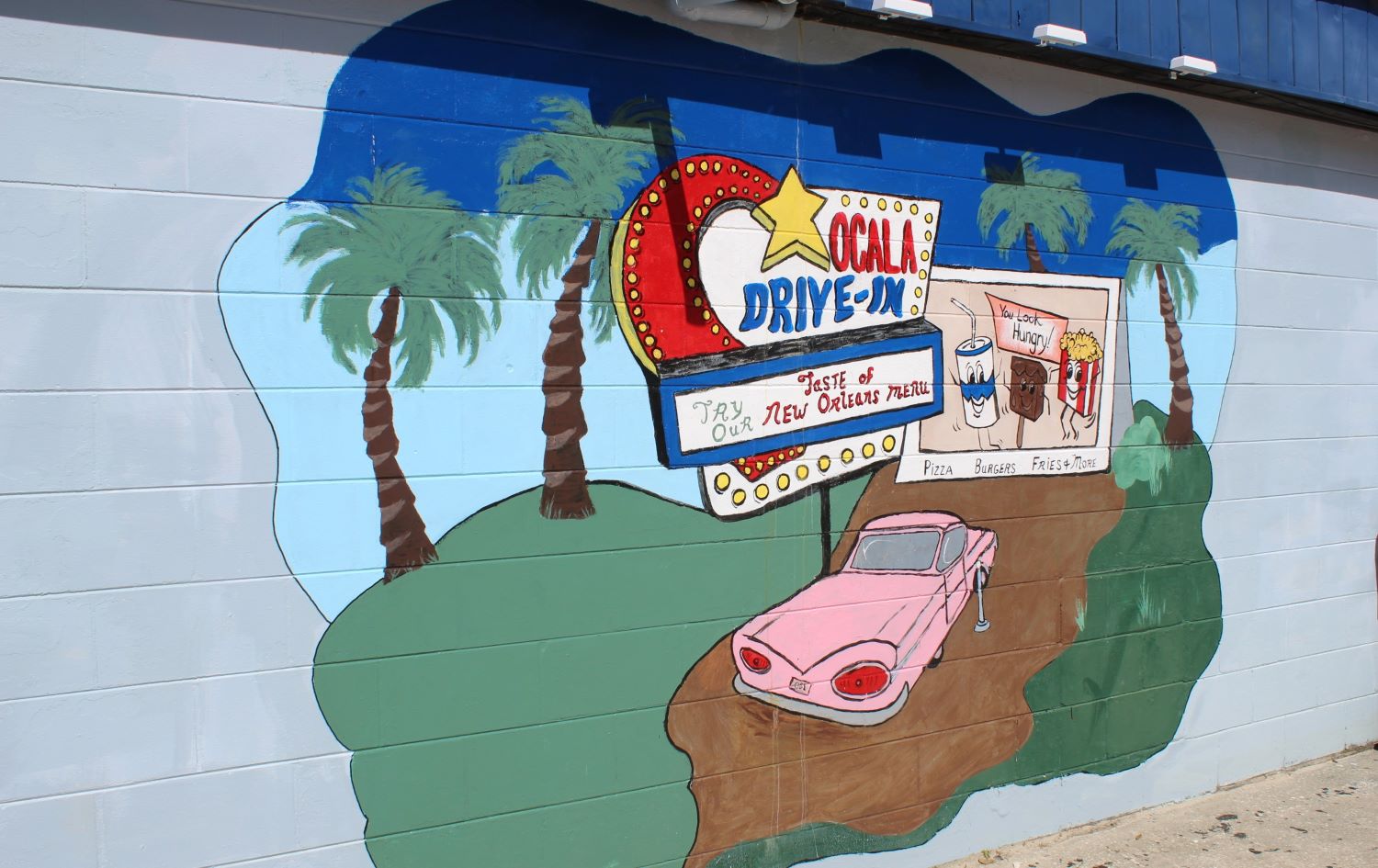 Mural of pink car at Ocala drive-in