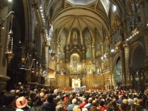 interior of a splendid basilica full of people in montserrat spain